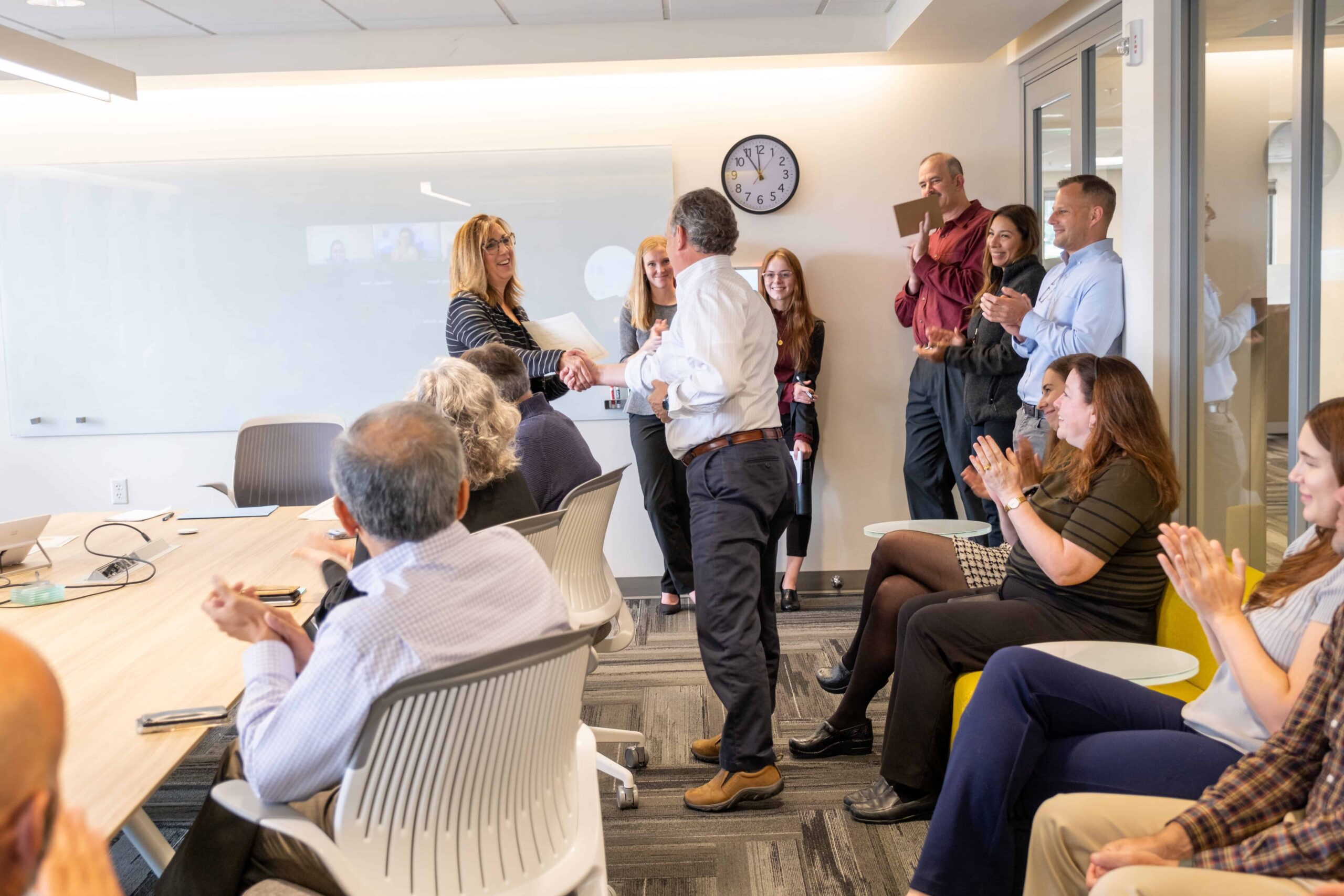 Group of people in a conference room shaking hands