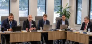 Board members sitting at table during meeting